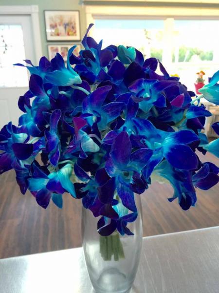 This beautiful wedding bouquet can be done by purchasing 2 bunches of our blue bomb orchids in the flower category and just cutting them and placing them into a bouquet holder and wrap with ribbon for beautiful wedding flowers