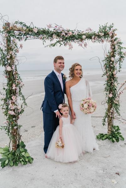 Love this simple beach wedding arch done with Florida and Carolina garlands Italian Ruscus, curly willow and silk cherry blossoms that the Pink Pelican Florist added to give this a beautiful back drop on the Beach... Florida Weddings at St Pete Florida, wedding photography Alyssa Frost Photography