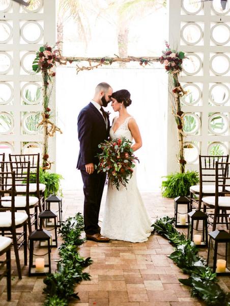 This wedding arch is done with our tropical  monstera leaves from our bunches selection and a custom fresh garland down the aisle the ideas are unlimited with Florida and Carolina Garlands. Great weddings happen at Costa d`Este Beach Hotel in Vero Beach Fl.