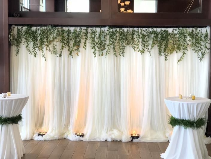 Florida and Carolina Garlands took this plain pipe and drape and turned it into something magical... If you would love this look to DIY just choose our collections and go to bunches and look for the Italian Ruscus decorations and order as many as you need and happy decorating!
